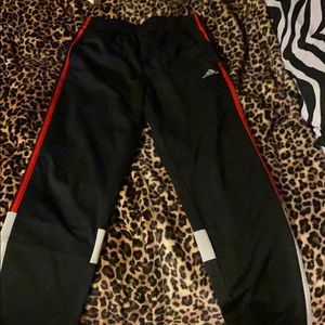 Black, red, and white Adidas pants